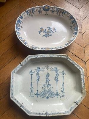 pair of blue and white plates on a wooden floor