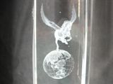 a glass vase with a picture of a bird on top of a globe