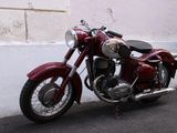 a red motorcycle parked on the side of the road