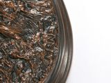 a close up of a metal object on a white surface