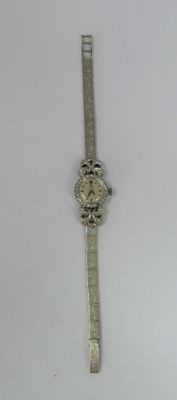 a watch that is sitting on a white surface