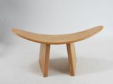 a small wooden bench that is on a white surface