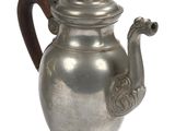 a silver teapot with a wooden handle on a white background