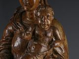 an image of a wooden statue of a woman holding a child