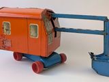 a toy train with a crane attached to it ' s side