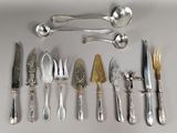 a lot of silver and silverware on the table
