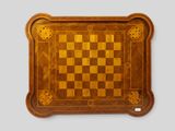 a close up of a wooden chess board with squares on it