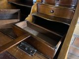 a drawer that is open on top of a wooden desk