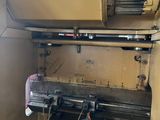a machine that is working on a piece of wood