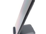 a cell phone on a stand on a white surface