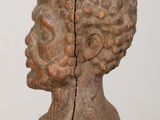 an old wooden sculpture of a man with his head in the shape of a bust