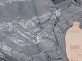 a pair of jeans on a plastic bag on the floor