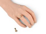 an image of a woman ' s hand with a gold ring on it