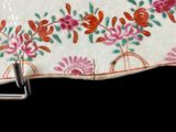 a plate with a floral design on it on a black background