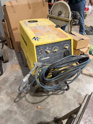 a man working on a machine in a garage
