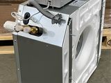 an image of a washing machine that is in the middle of a pile of boxes