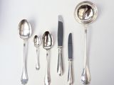 five spoons, a knife, and a spoon on a table