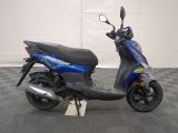 the scooter is parked in the garage on the checkered floor