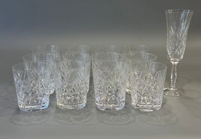 six glasses and a wine glass sitting on a table
