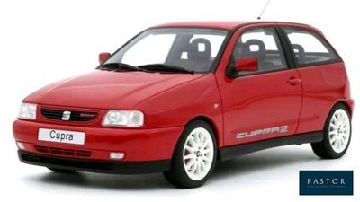 the small red car is parked on a white surface