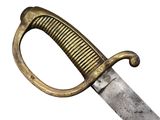 a close up of a knife with a gold handle on a white background