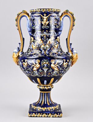 a blue and gold vase sitting on a white surface