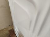 a white bath tub sitting in a bathroom next to a toilet