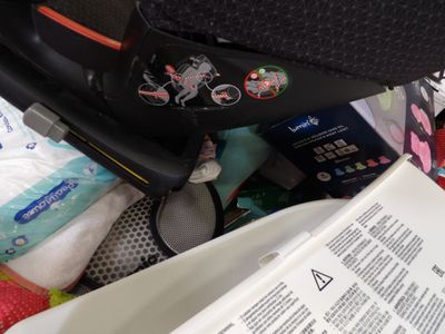 a black suitcase sitting on top of a pile of diapers