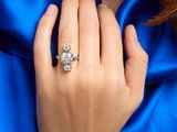 an image of a woman ' s hand with a diamond ring on her finger