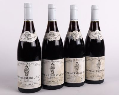four bottles of wine are lined up in a row on a table