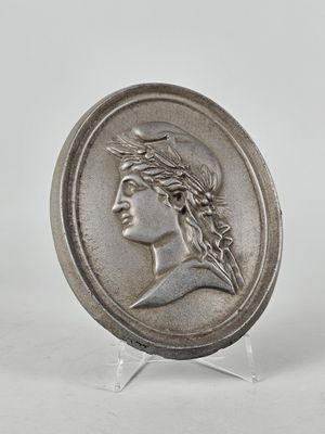 a close up of a coin with a woman ' s face on it