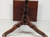a small wooden table with a metal holder on it