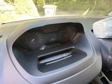 a dashboard of a car with a view of a forest