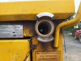 a close up of a yellow machine with a chain attached to it