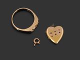 two gold rings and a heart shaped locke on a black background