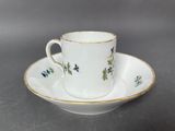 a cup and saucer on a saucer on a table