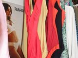 a lot of clothes hanging on a rack in a store