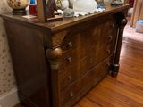 a dresser with a lot of things on top of it