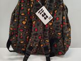 the back of a leopard print backpack with a tag on it