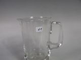a clear glass cup with a sticker on it