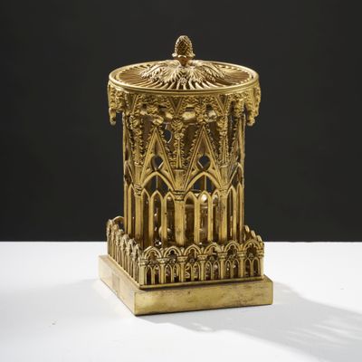 a gold statue of a tower with a clock on top