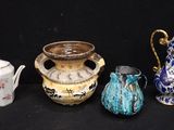 Plusieurs types de vases sont alignés sur une surface noire