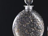 a glass bottle with a silver lid and a glass bottle with a silver lid