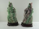 pair of jade figurines of a man and a woman on a rock