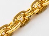 a close up of a gold chain bracelet on a white surface
