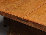 a close up of a wooden table with a drawer underneath it