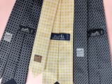 three different colored ties with different designs on them on a pink background