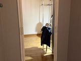 a mirror in the corner of a room with a chair