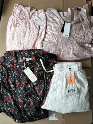 three pairs of women ' s shorts and a shirt in a box
