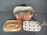 three copper pans with lids and handles on a table